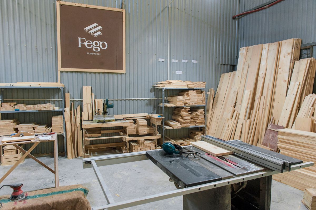 Plywood and hardware workshop with lumber stacks