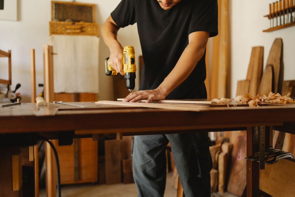 Close-up of carpenter working with wood plank